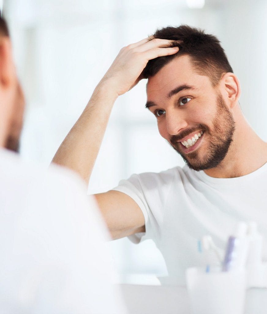 cosmetic dentistry man smiles with new confidence