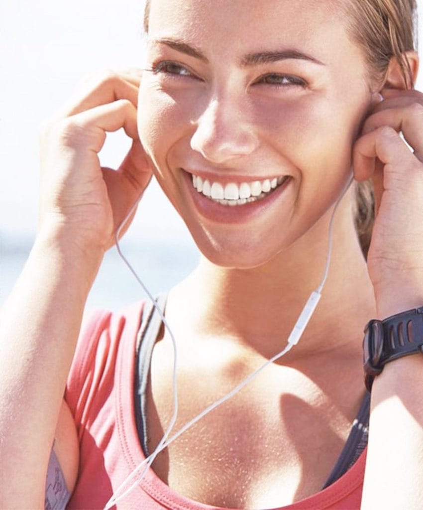 sporty girl smiles with confidence with veneers