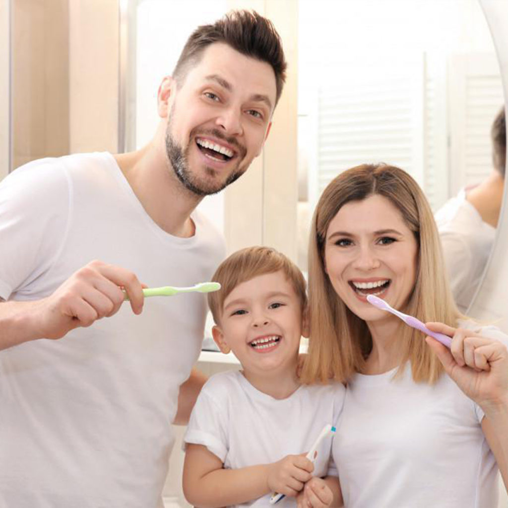 family brushing teeth after gum disease treatment