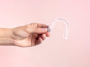 Invisalign in hand Smile Concepts